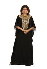Woman wearing a black dress with gold embroidery on a white background