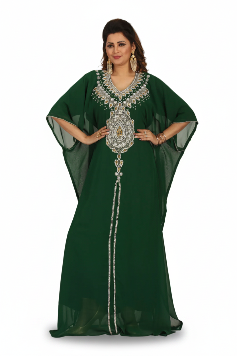 Woman wearing a green dress with intricate silver embroidery on a white background