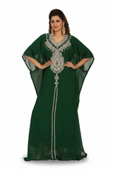 Woman wearing a green dress with intricate silver embroidery on a white background